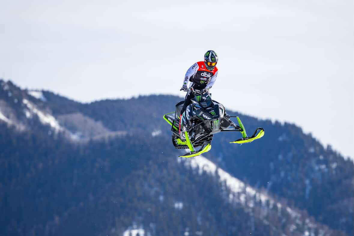 Willie Elam launching off a mountain jump in dbk gear